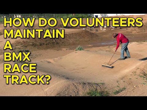 How do volunteers maintain a BMX track?